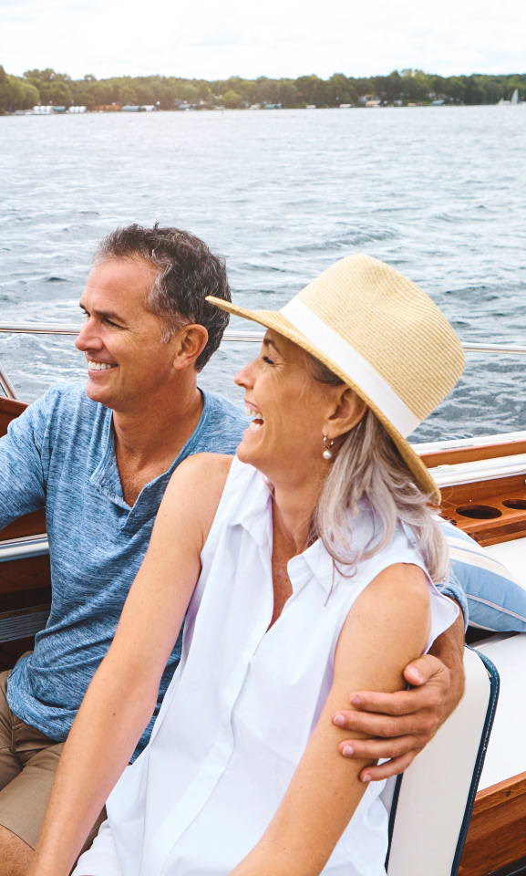 Middle aged couple cruising on boat